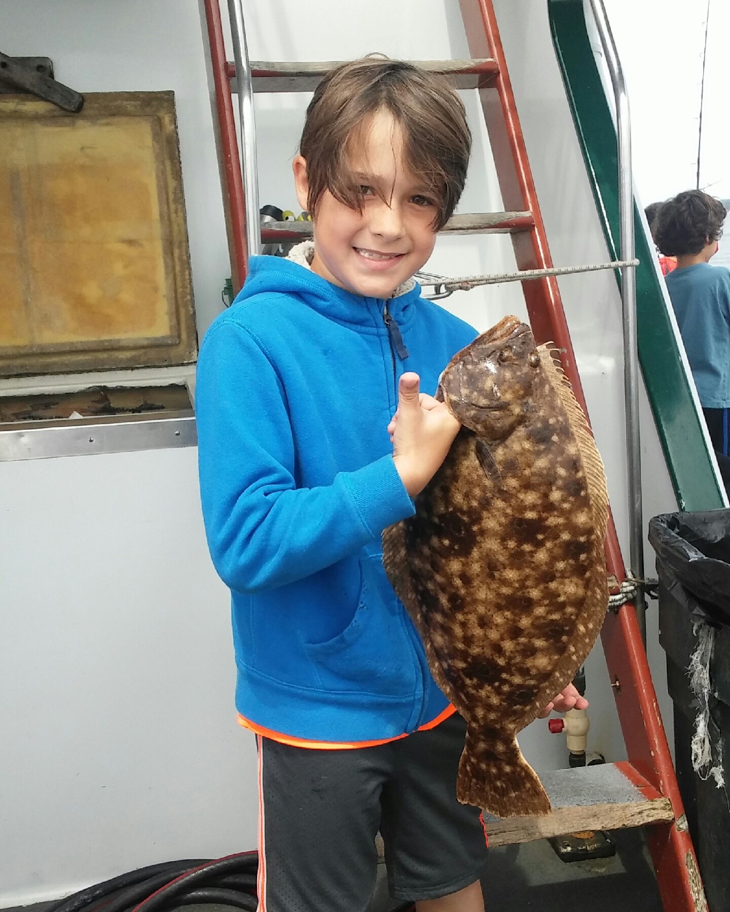 Noah Blasi of Warwick with the 22” summer flounder (fluke) he caught at the RI Saltwater Anglers Association fishing camp.