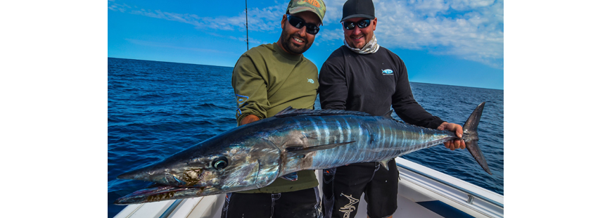 Captains DeFusco and Sprengle of East Coast Charters with a wahoo they caught in warm August water off Rhode Island.