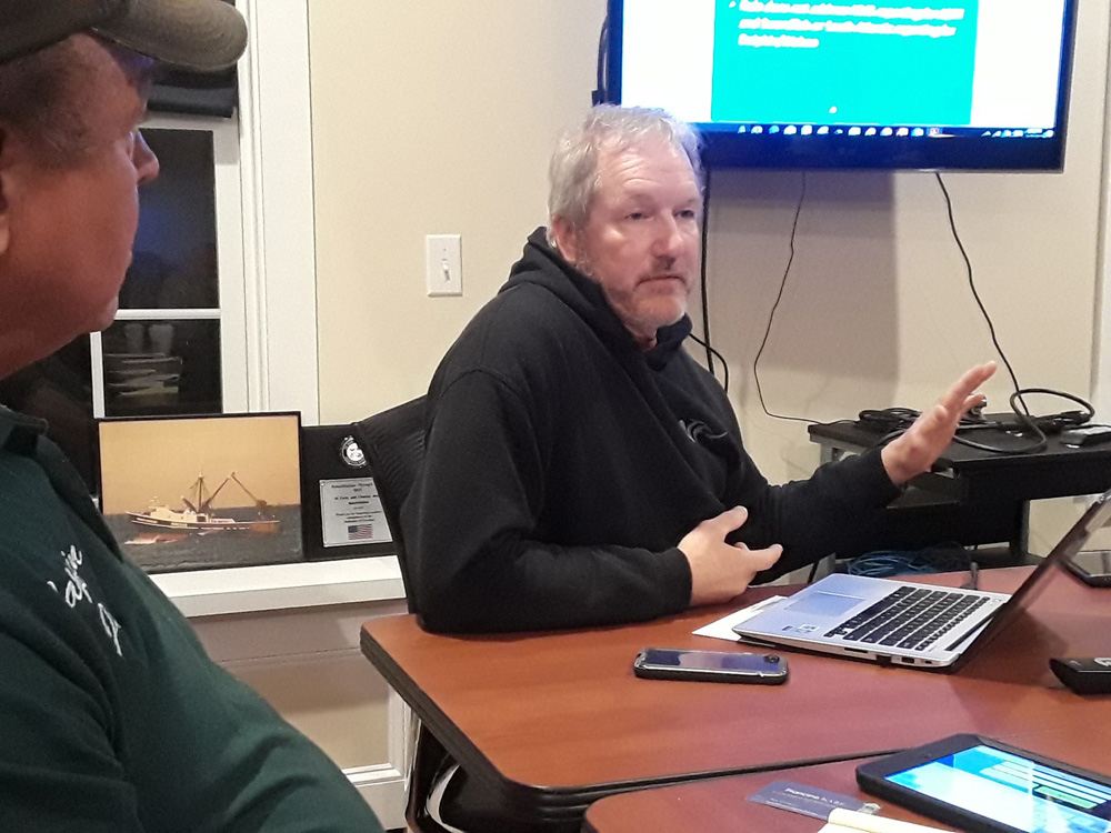 Capt. Rick Bellavance, president of the RI Party & Charter Boat Association, relates the advantages of electronic catch recording as Capt. Joe Bleczinski looks on.