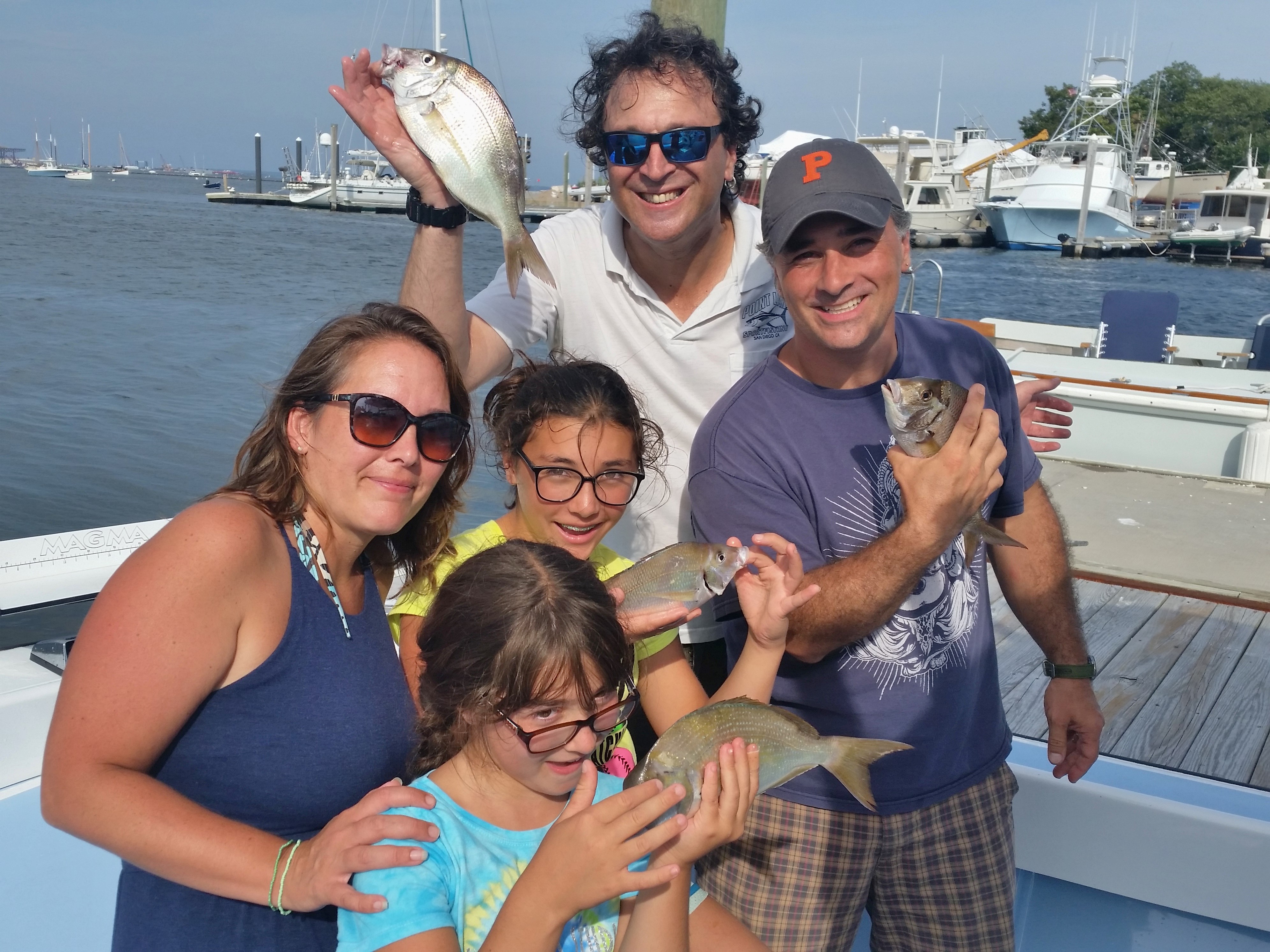 Mikele St.-Germain, daughters Eva and Francesca, husband Pierre and friend Steve Brustein (back row) enjoyed scup fishing last summer. The scup, an underutilized species, were cooked on the grille for dinner.