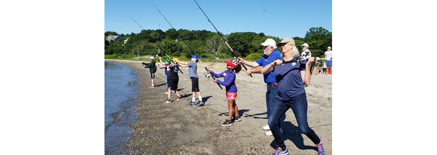 Janet Coit, DEM Director; Steve Medeiros, RISAA president/camp director; and camp participants held a cast-off to open the third annual RISAA Youth Fishing Camp.
