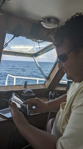 Captain Jim Green using a tablet for reporting trip information while at sea.