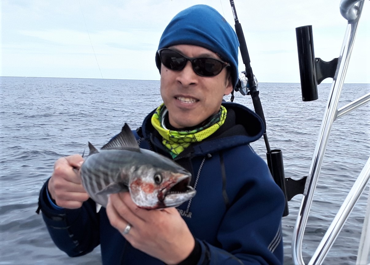 Jamie Wong of Cambridge, MA with a 21” bonito caught in November off Newport, RI. Climate change has brought warm water bait and fish to the region for longer periods of time.