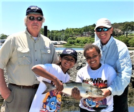 Over 250 RISAA volunteers are needed to run your average Take-A-Kid Fishing Day and about 50 volunteers are needed to run its three-day camp program for youth. Children shown with bluefish.