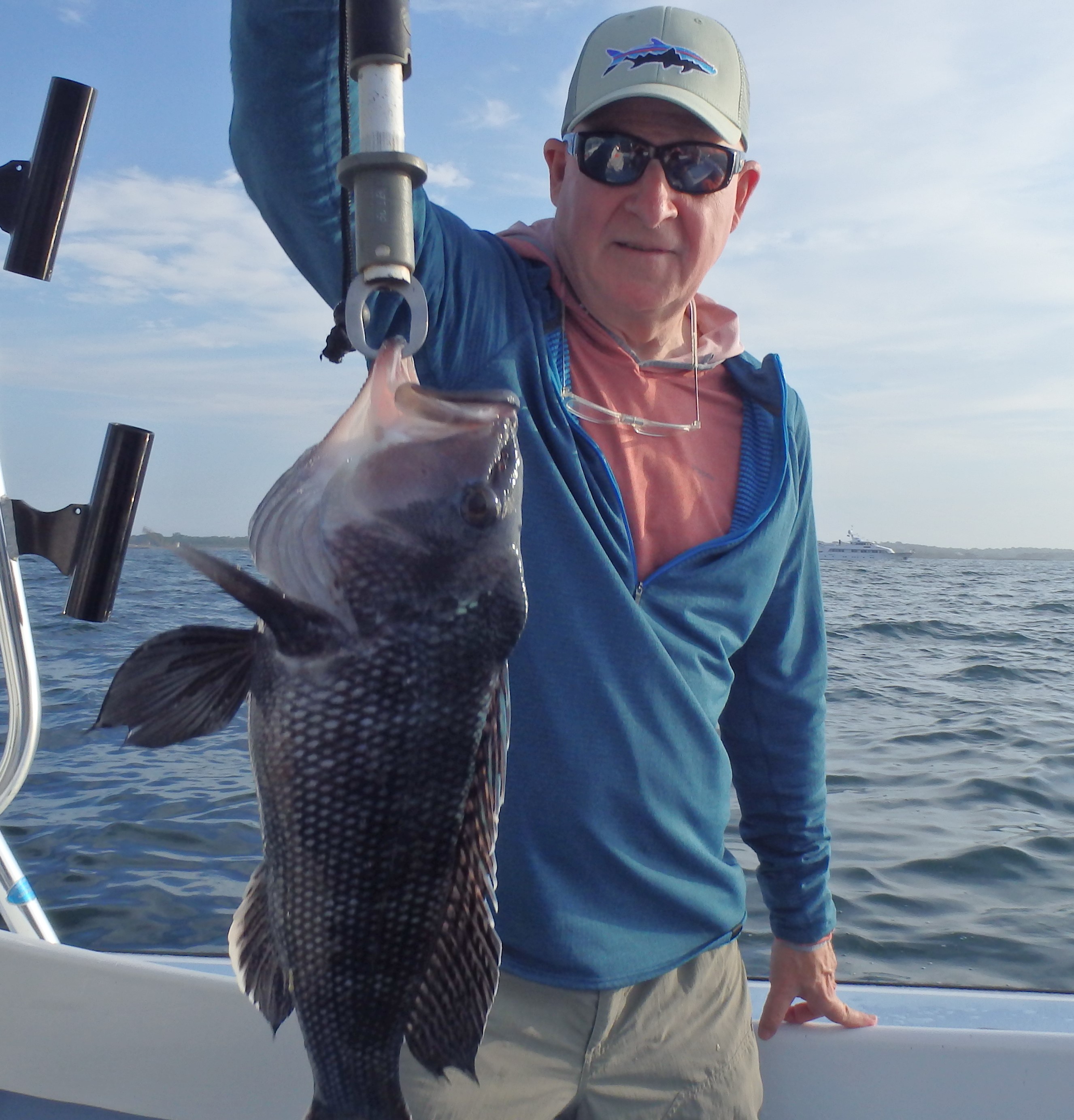 Tom Sadler, deputy director of the Marine Fish Conservation Network, with a 20” black sea bass he caught off Newport, RI. Black sea bass are plentiful in the northeast in part due to climate change.
