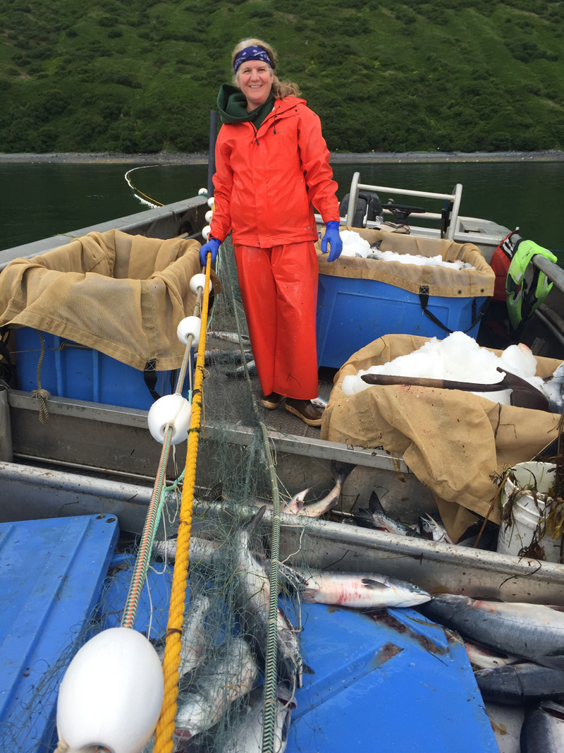 Theresa in the skiff picking setnet salmon