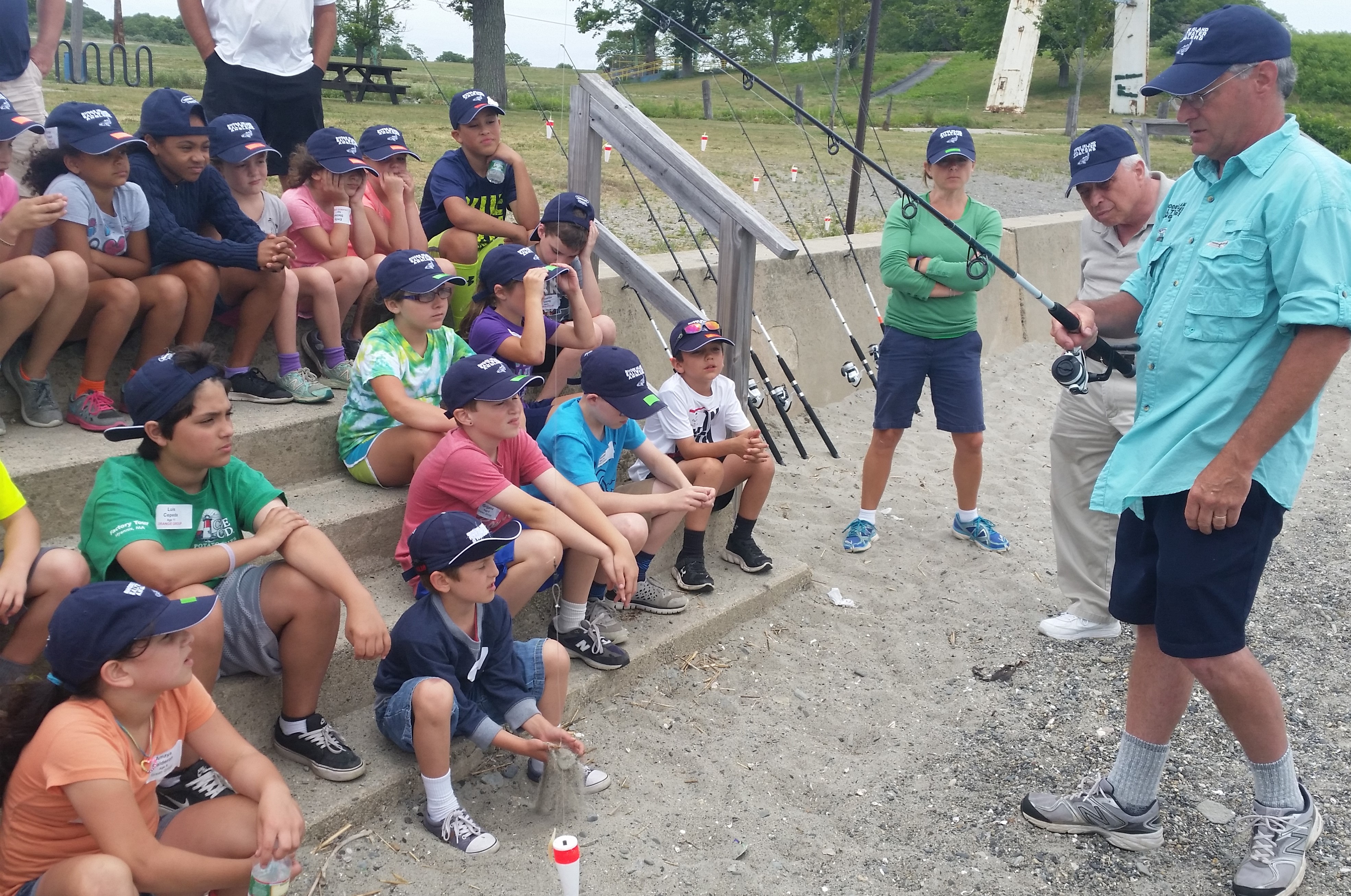 Top: Fishing appeals to our sense of adventure and builds a lifetime of memories with family and friends. Above: Richard Reich, lead surfcasting instructor, explains some of the fundamentals of casting to youth fishing camp participants on Rocky Point Beach, Warwick, RI.