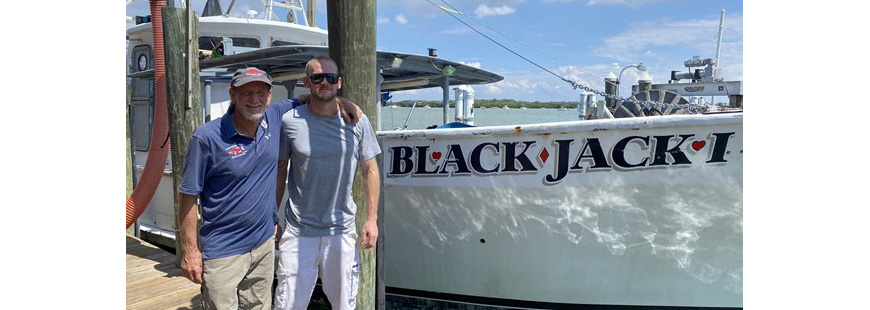 Captain Bobby Carter and son Captain Nick Carter stand together in front of F/V Blackjack I. This multi-generational fishing duo run two boats out of Wild Seafood Co. in Madeira Beach, FL and caught fish for the first round of fish processed and donated to the St. Pete Free Clinic.