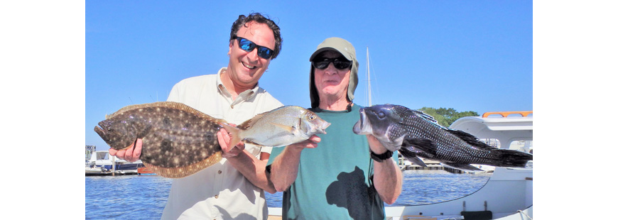 Steve Brustein and Michael Weaver with summer flounder, scup and black sea bass (warm water fish) they caught in Narragansett Bay this summer. Cold water fish like winter flounder have moved out.